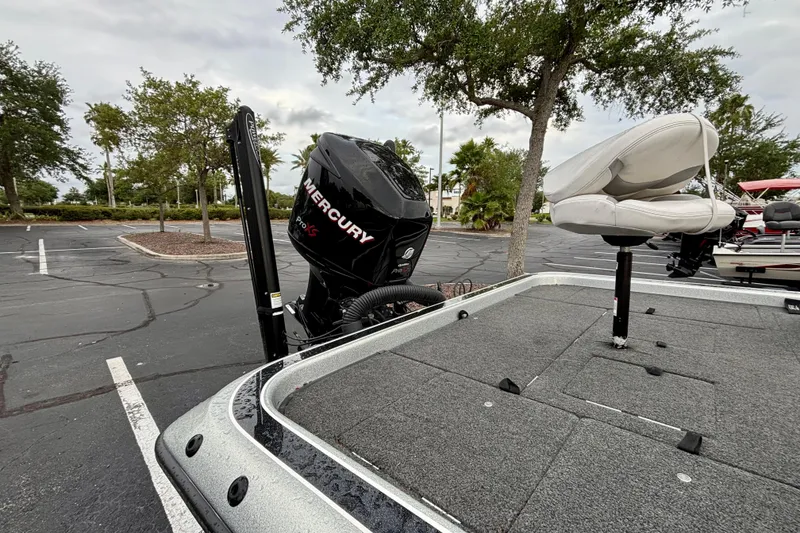 Slide: The Image of 2006 Champion 198 Elite boat with Mercury Pro XS engine in a parking lot. - 7