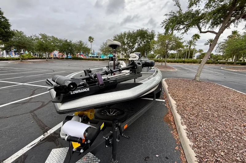 Slide: The Image of 2006 Champion 198 Elite boat with Lowrance equipment in a parking lot. - 9