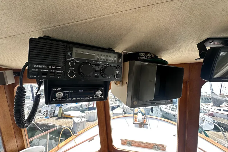 Slide: The Image of Boat interior with Icom IC-M700 radio, Furuno radar, and marina view, CHB 33, 1973 model. - 18
