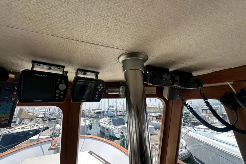 Slide: The Image of Interior of a 1973 CHB 33 boat with navigation equipment and marina view. - 19