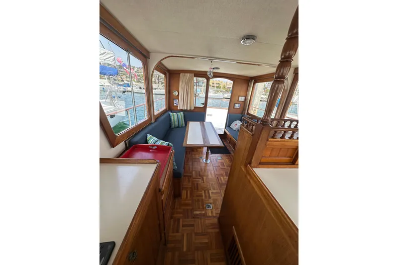 Slide: The Image of Interior of a 1973 CHB 33 boat with wooden furnishings and a cozy seating area. - 20