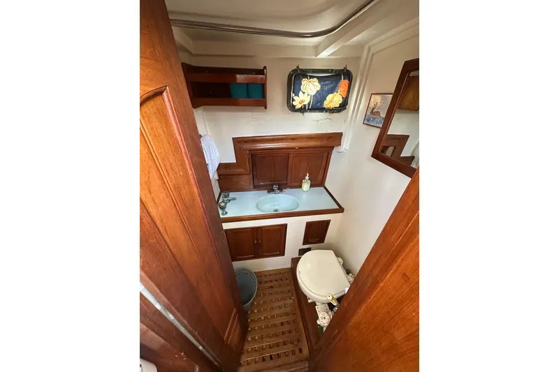 Slide: The Image of 1973 CHB 33 boat bathroom with wooden cabinetry and nautical decor. - 26
