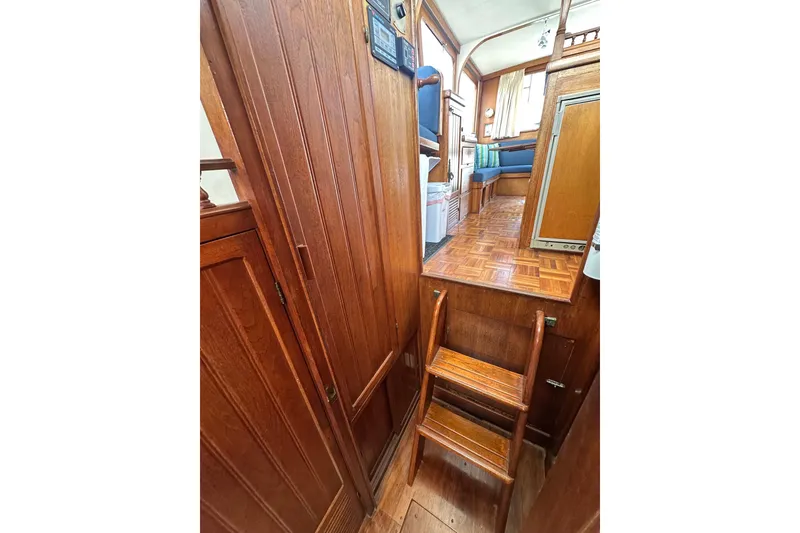 Slide: The Image of Interior of a 1973 CHB 33 boat featuring wooden stairs and seating area. - 30