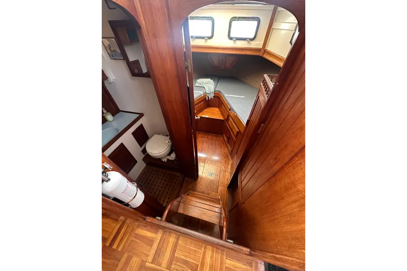 Slide: The Image of Interior of 1973 CHB 33 boat with wooden finish, showing cabin and bathroom. - 31