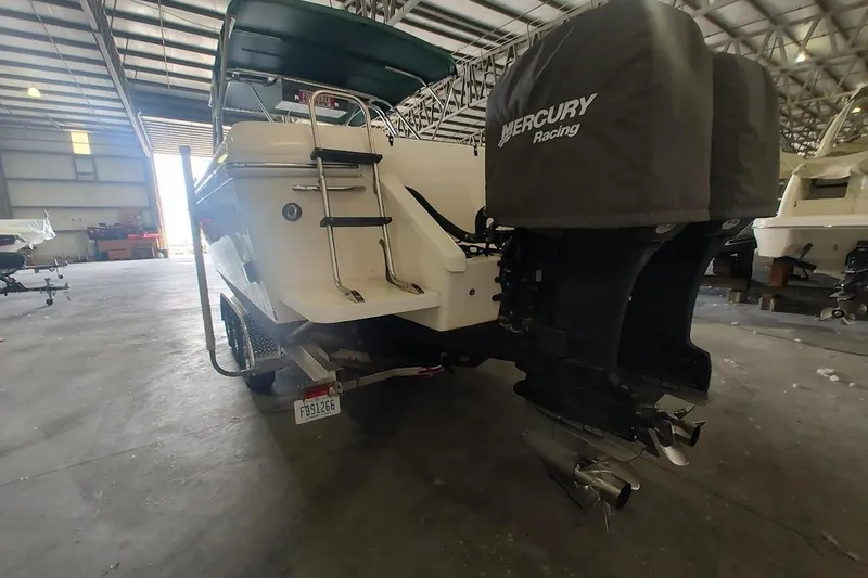 Slide: The Image of 1994 Intrepid 322 Cuddy boat with Mercury Racing engines in a storage facility. - 10