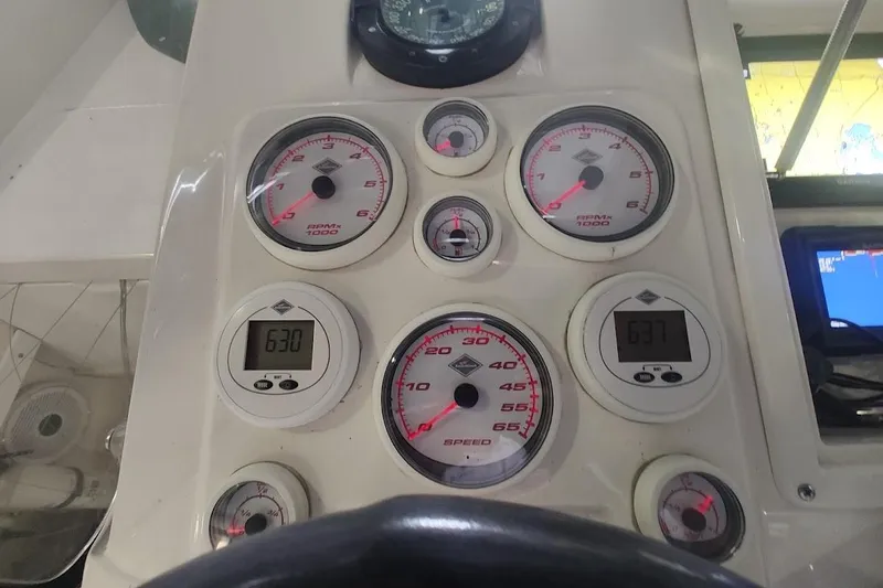 Slide: The Image of Dashboard of a 1994 Intrepid 322 Cuddy boat with gauges and digital displays. - 16