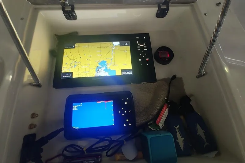 Slide: The Image of Navigation equipment inside a 1994 Intrepid 322 Cuddy boat, featuring GPS and sonar displays. - 17