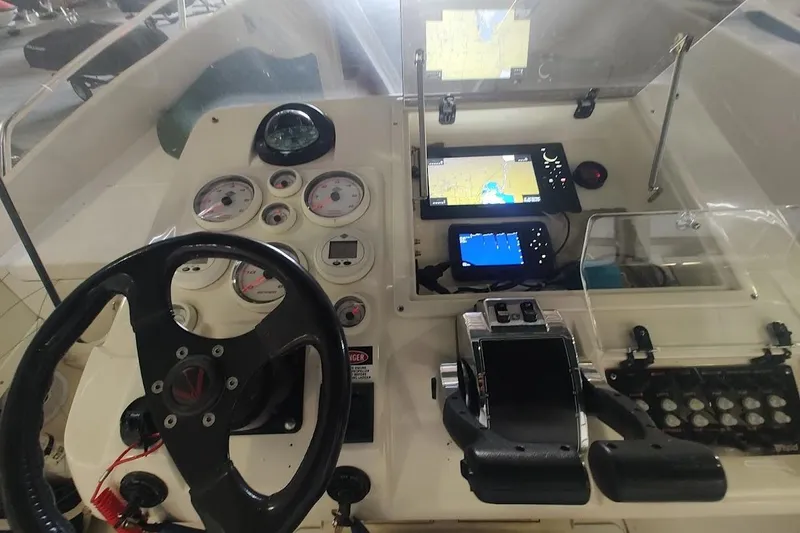 Slide: The Image of 1994 Intrepid 322 Cuddy helm with steering wheel, gauges, and navigation screens. - 18