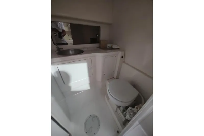 Slide: The Image of 1994 Intrepid 322 Cuddy boat bathroom with sink and toilet. - 22