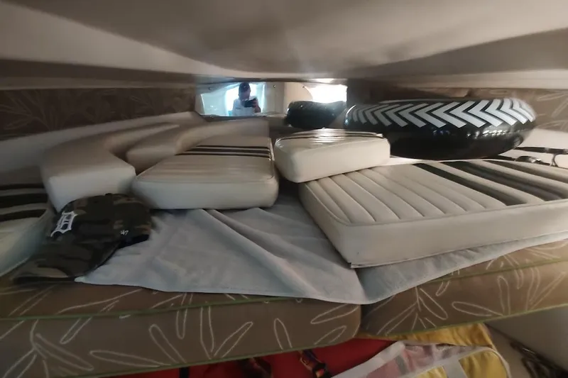Slide: The Image of Interior of a 1994 Intrepid 322 Cuddy boat with cushions and inflatable tube. - 23