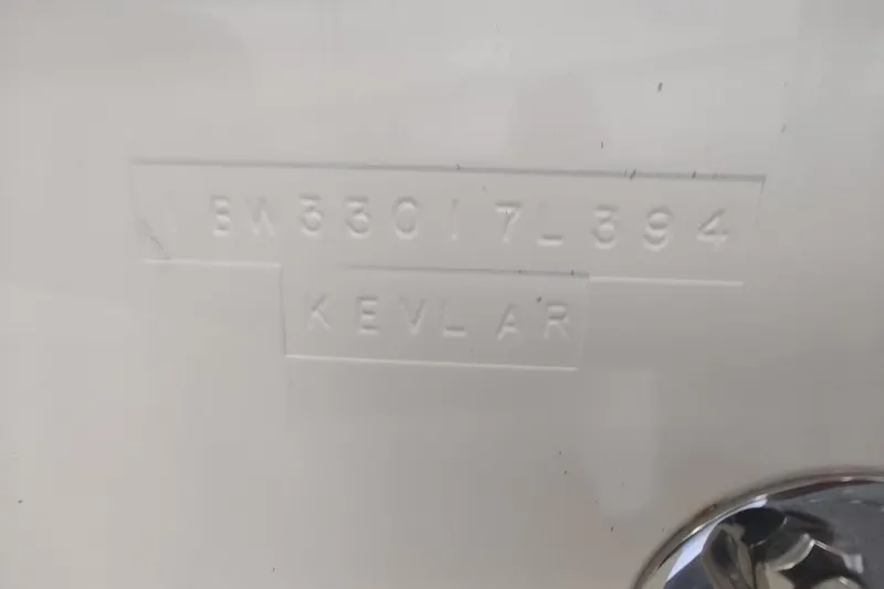 Slide: The Image of 1994 Intrepid 322 Cuddy boat hull with embossed serial number and Kevlar label. - 24