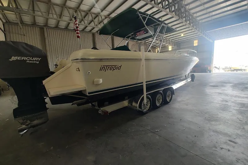 Slide: The Image of 1994 Intrepid 322 Cuddy boat with Mercury Racing engine in a spacious warehouse. - 5