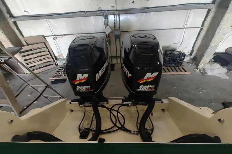 Slide: The Image of Twin Mercury OptiMax 250 engines on a 1994 Intrepid 322 Cuddy boat in a garage. - 7