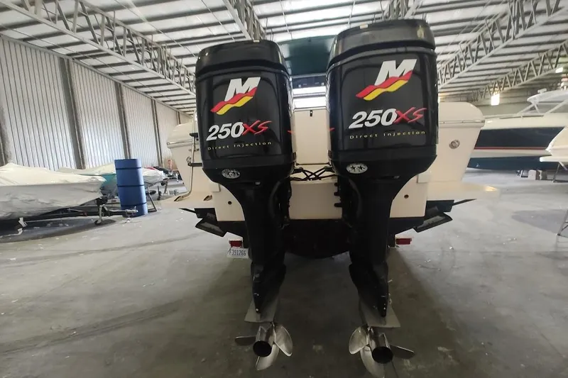 Slide: The Image of 1994 Intrepid 322 Cuddy with twin 250XS outboard engines in a storage facility. - 1