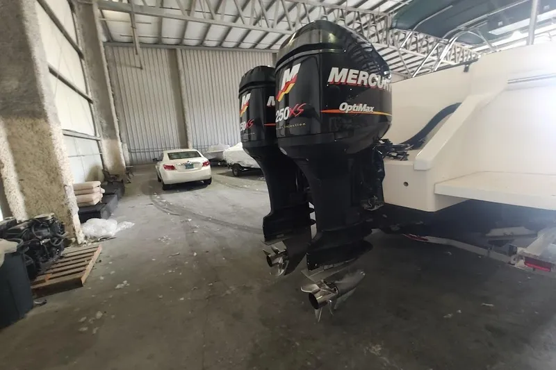 Slide: The Image of 1994 Intrepid 322 Cuddy with twin Mercury OptiMax engines in a storage facility. - 8