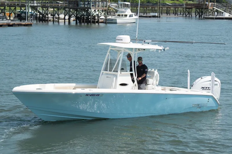The Image of 2024 Pathfinder 2700 Open boat cruising on water near docks. - 1