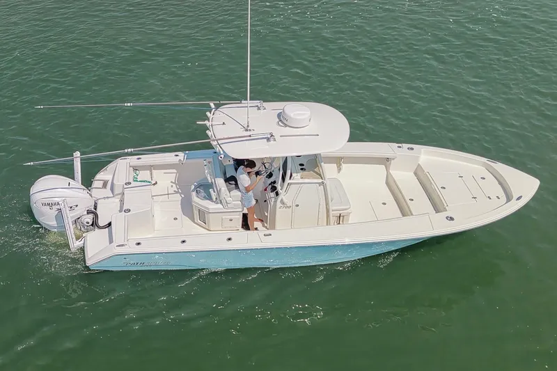 Slide: The Image of 2024 Pathfinder 2700 Open boat cruising on clear water, featuring a sleek design and Yamaha engine. - 10