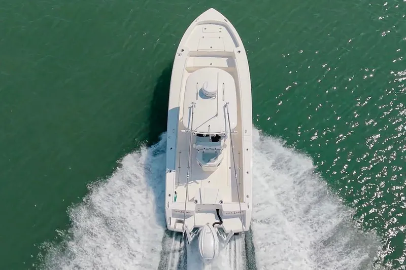 Slide: The Image of Aerial view of 2024 Pathfinder 2700 Open boat cruising on water. - 12