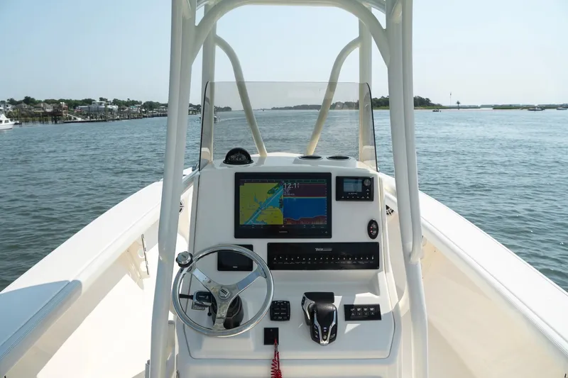 Slide: The Image of 2024 Pathfinder 2700 Open boat console with navigation system on calm water. - 14