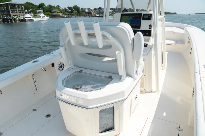 Slide: The Image of 2024 Pathfinder 2700 Open boat interior with helm station and rod holders on a sunny day. - 15