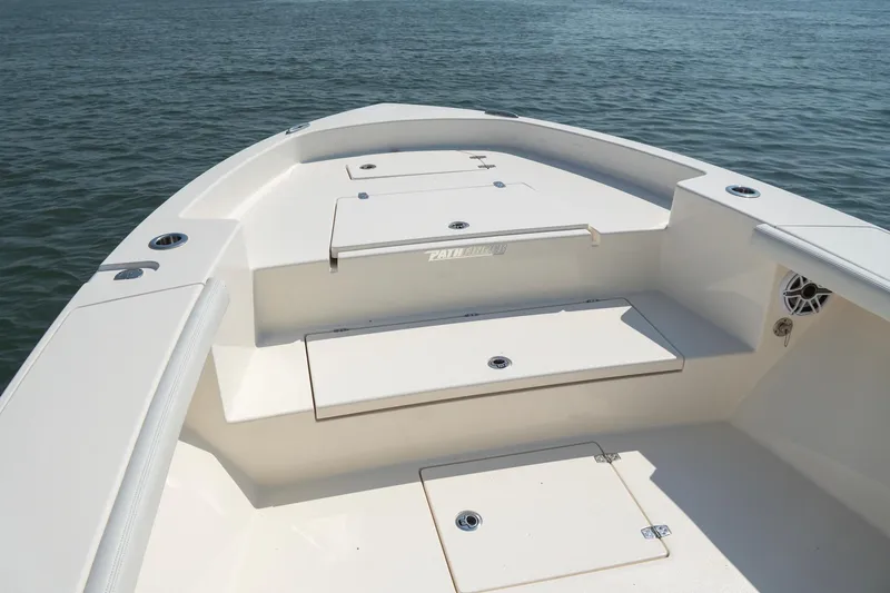 Slide: The Image of 2024 Pathfinder 2700 Open boat deck with storage compartments on calm water. - 16