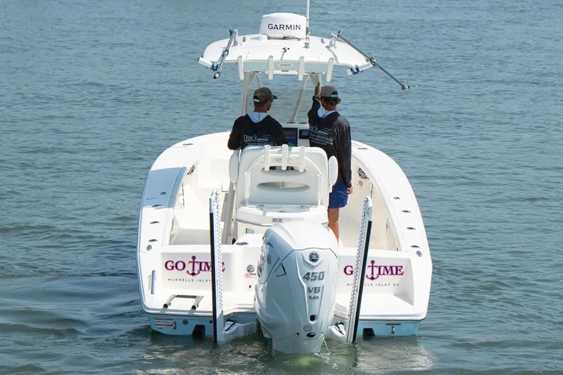 Slide: The Image of 2024 Pathfinder 2700 Open boat with Garmin equipment on water, rear view. - 5