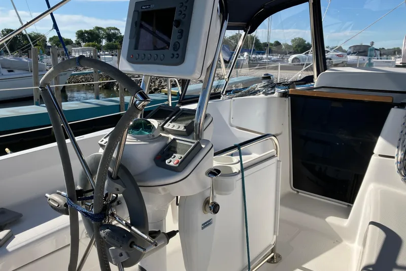 Slide: The Image of Cockpit of a 2005 Hunter 36 sailboat with navigation equipment and steering wheel. - 56