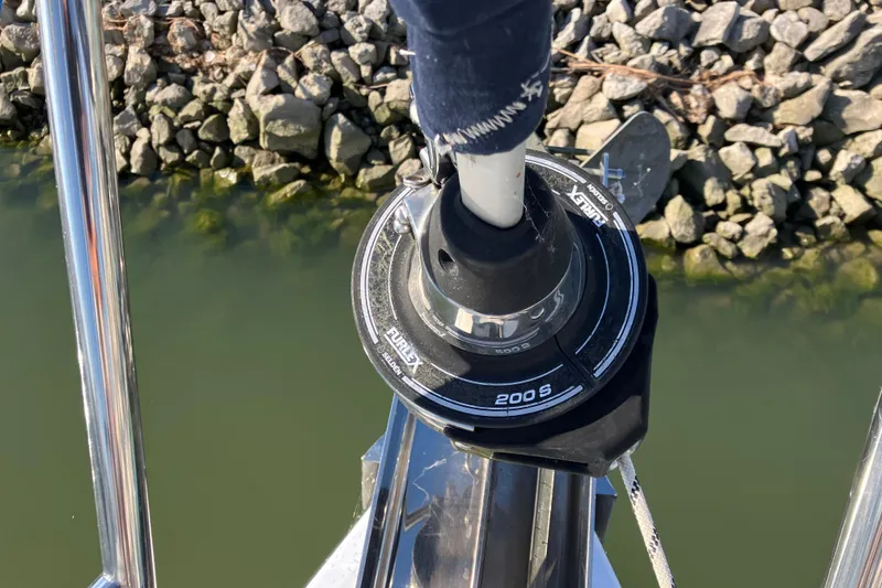 Slide: The Image of Furlex 200S roller furling system on a 2005 Hunter 36 sailboat, near rocky shoreline. - 18