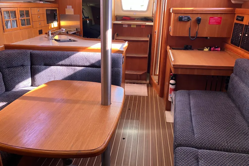 Slide: The Image of Interior of a 2005 Hunter 36 sailboat with wood finishes and seating area. - 41