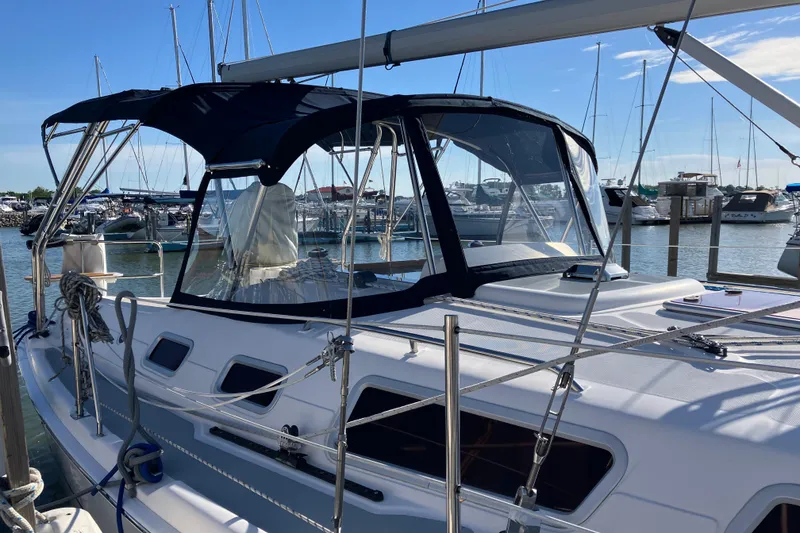 Slide: The Image of 2005 Hunter 36 sailboat docked at marina under clear blue sky. - 6