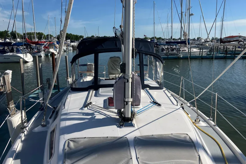 Slide: The Image of 2005 Hunter 36 sailboat docked at marina, surrounded by other boats under clear blue sky. - 19