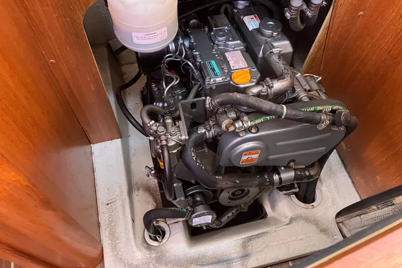 Slide: The Image of Engine compartment of a 2005 Hunter 36 sailboat, showcasing detailed mechanical components. - 48