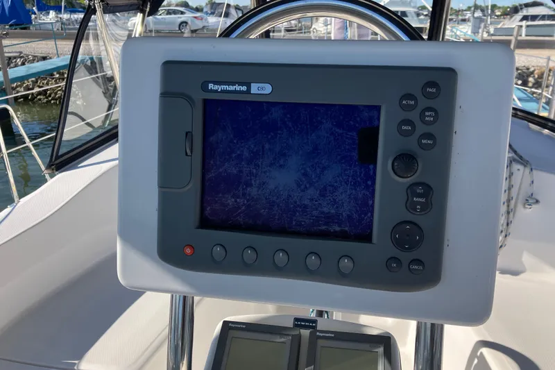 Slide: The Image of Raymarine navigation system on a 2005 Hunter 36 sailboat, docked at a marina. - 53
