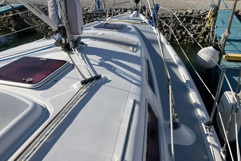 Slide: The Image of 2005 Hunter 36 sailboat deck with rigging and hatches, docked at marina. - 15