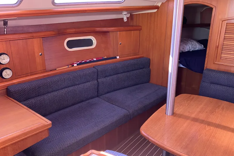 Slide: The Image of Interior of a 2005 Hunter 36 sailboat with cozy seating and wooden finishes. - 37