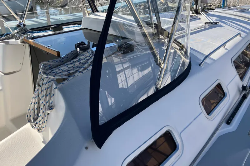 Slide: The Image of 2005 Hunter 36 sailboat deck with ropes and clear canopy, showcasing sleek design. - 14