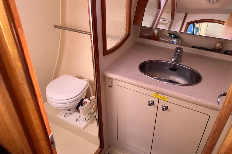 Slide: The Image of Compact bathroom in a 2005 Hunter 36 yacht with sink, mirror, and marine toilet. - 49
