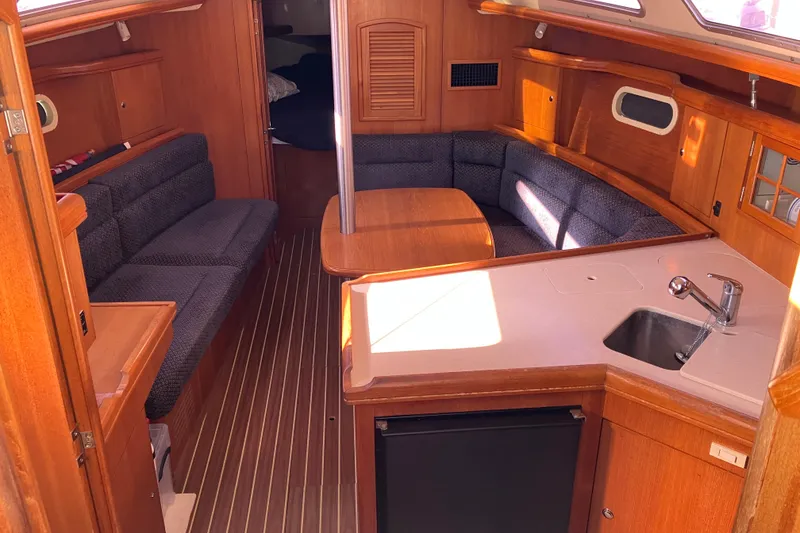 Slide: The Image of Interior of a 2005 Hunter 36 sailboat with wood finish and cozy seating area. - 29