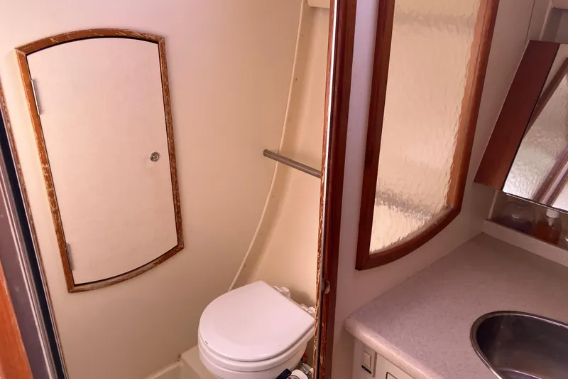 Slide: The Image of Compact bathroom in a 2005 Hunter 36 sailboat, featuring a toilet and sink. - 52
