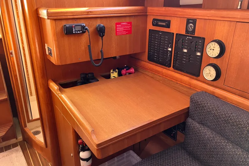 Slide: The Image of Navigation station in a 2005 Hunter 36 sailboat with communication equipment and control panels. - 33