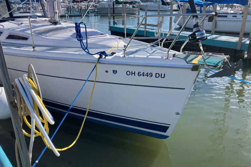 Slide: The Image of Hunter 36 sailboat from 2005 docked at a marina, with visible registration number. - 5