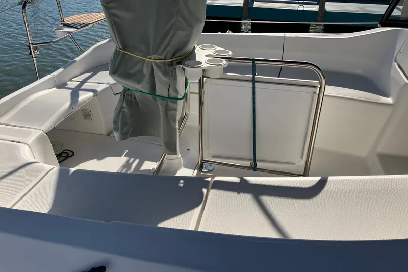 Slide: The Image of Cockpit of a 2005 Hunter 36 sailboat with covered steering and cup holders. - 13