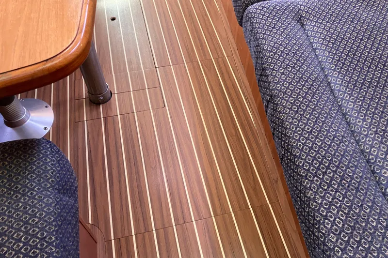 Slide: The Image of Interior of a 2005 Hunter 36 sailboat featuring wood flooring and patterned seating. - 39