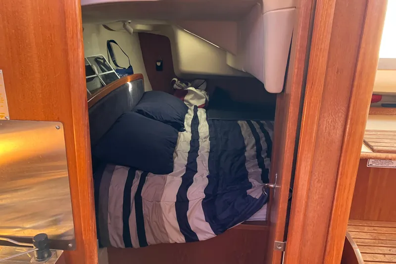 Slide: The Image of Cozy cabin interior of 2005 Hunter 36 sailboat with striped bedding. - 43