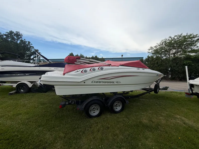 Slide: The Image of A 2012 Chaparral 206 SSi boat on a trailer, parked on grass. - 3