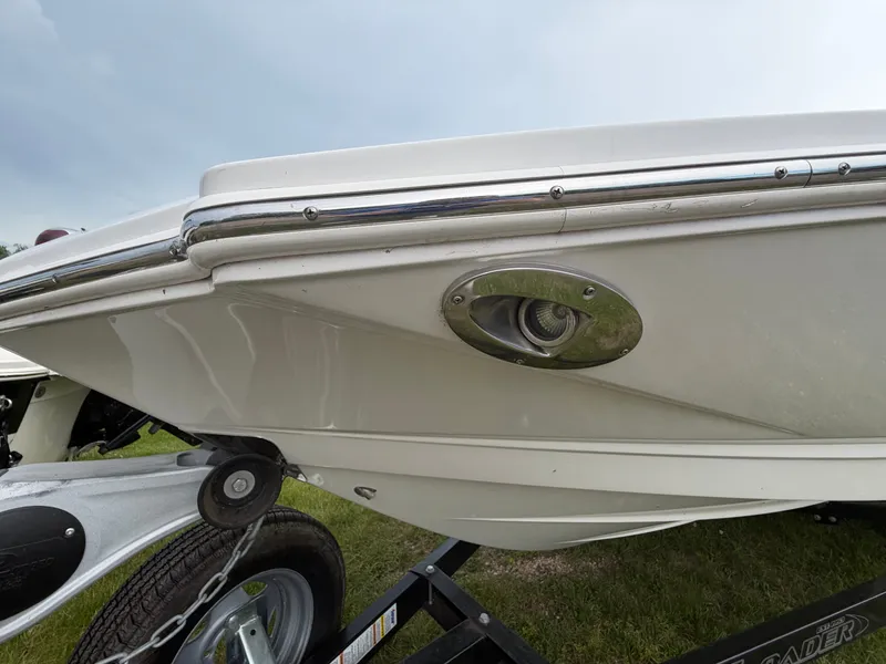 Slide: The Image of Close-up of the bow of a white Chaparral 206 SSi boat on a trailer. - 9
