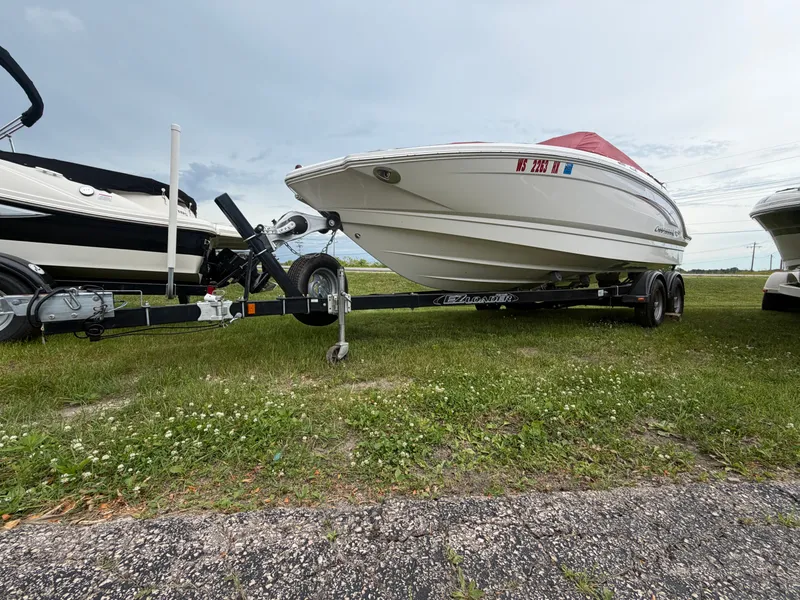 Slide: The Image of A white 2012 Chaparral 206 SSi boat on a trailer, parked on grass. - 12