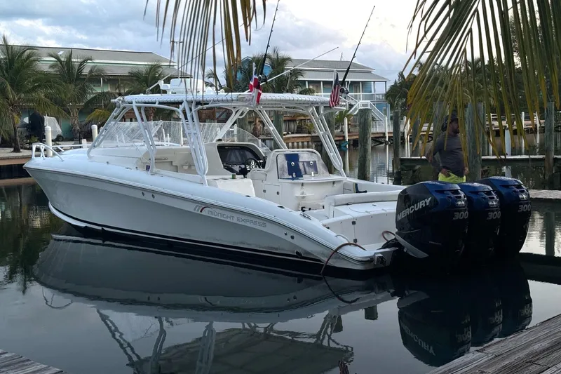 Slide: The Image of 2008 Midnight Express 37 Cabin boat docked with triple Mercury engines. - 1