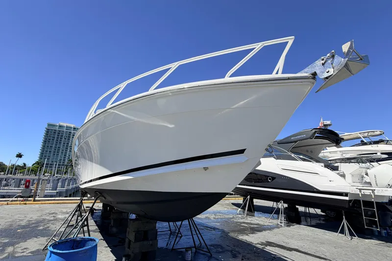 Slide: The Image of 2008 Midnight Express 37 Cabin boat on dry dock under clear blue sky. - 11
