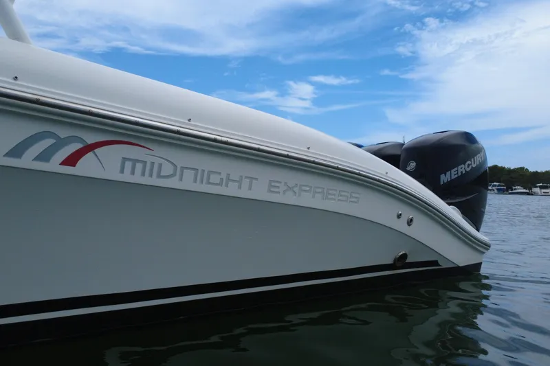 Slide: The Image of 2008 Midnight Express 37 Cabin boat with Mercury engines on a calm water background. - 19
